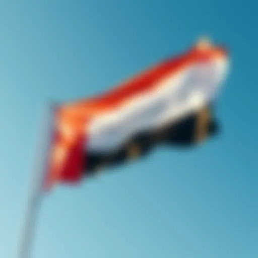 The UAE flag waving proudly against a clear blue sky